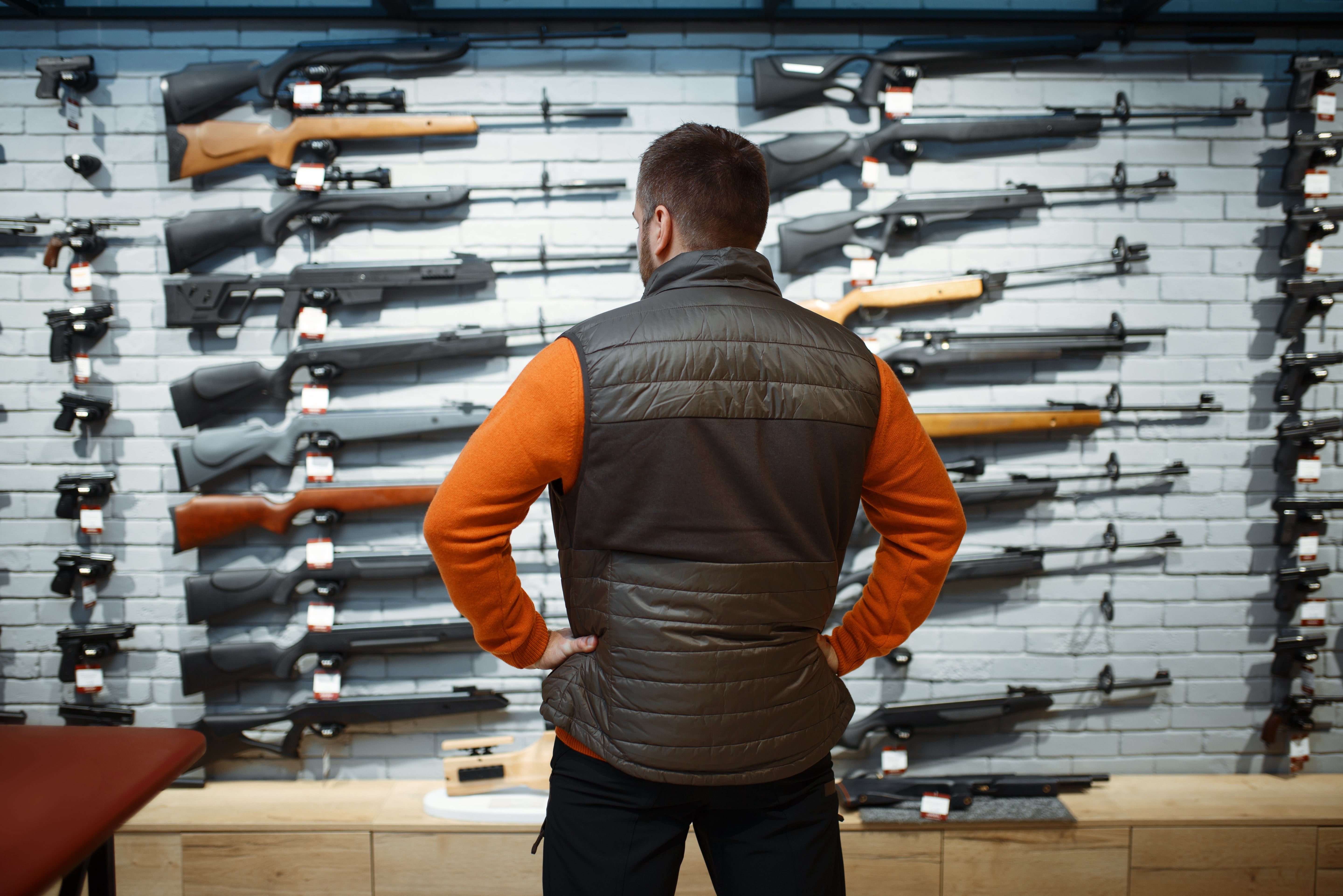 A smart gun safe organization idea for your collection. A man looking at his gun collection