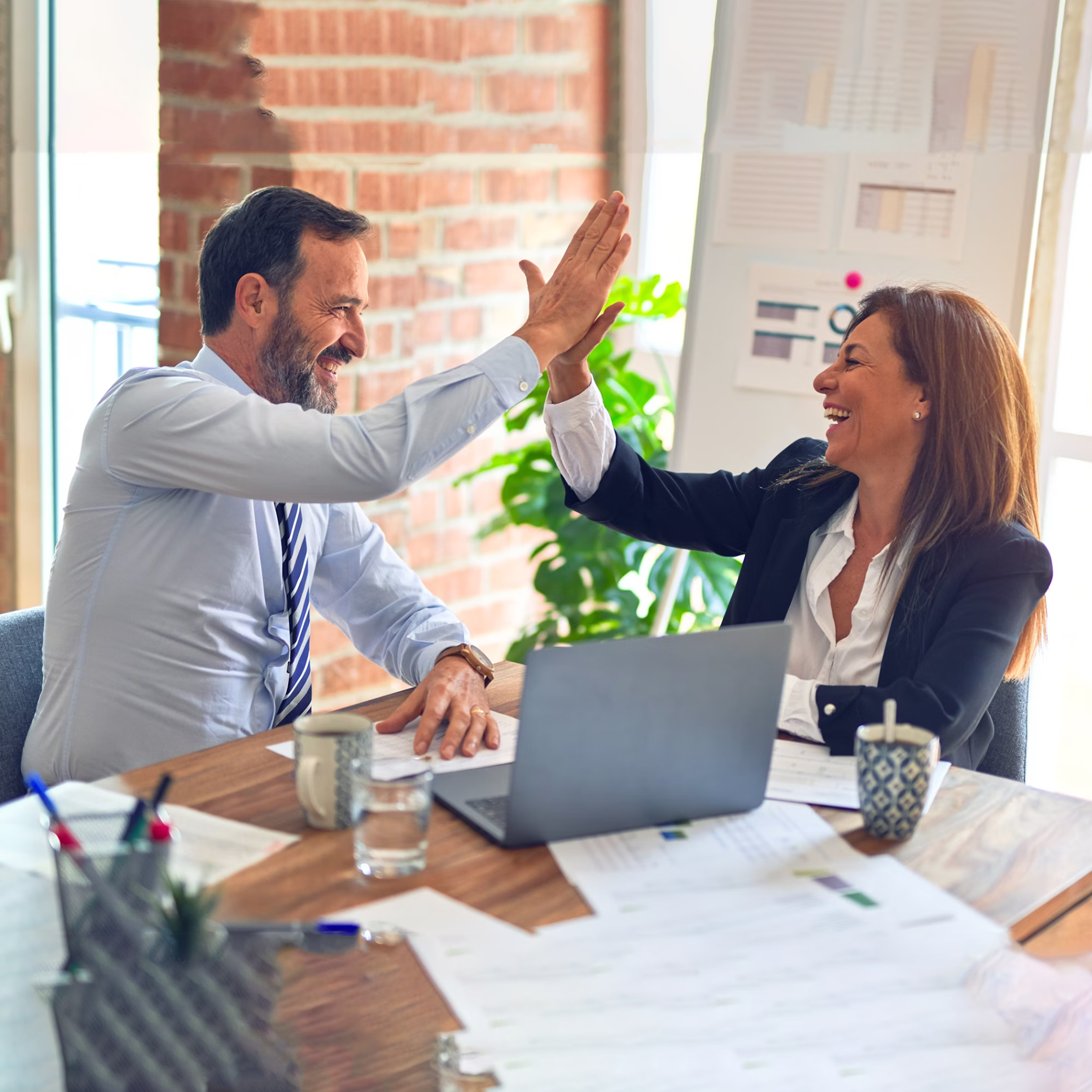 two people celebrating their deal on safe wholesale supply